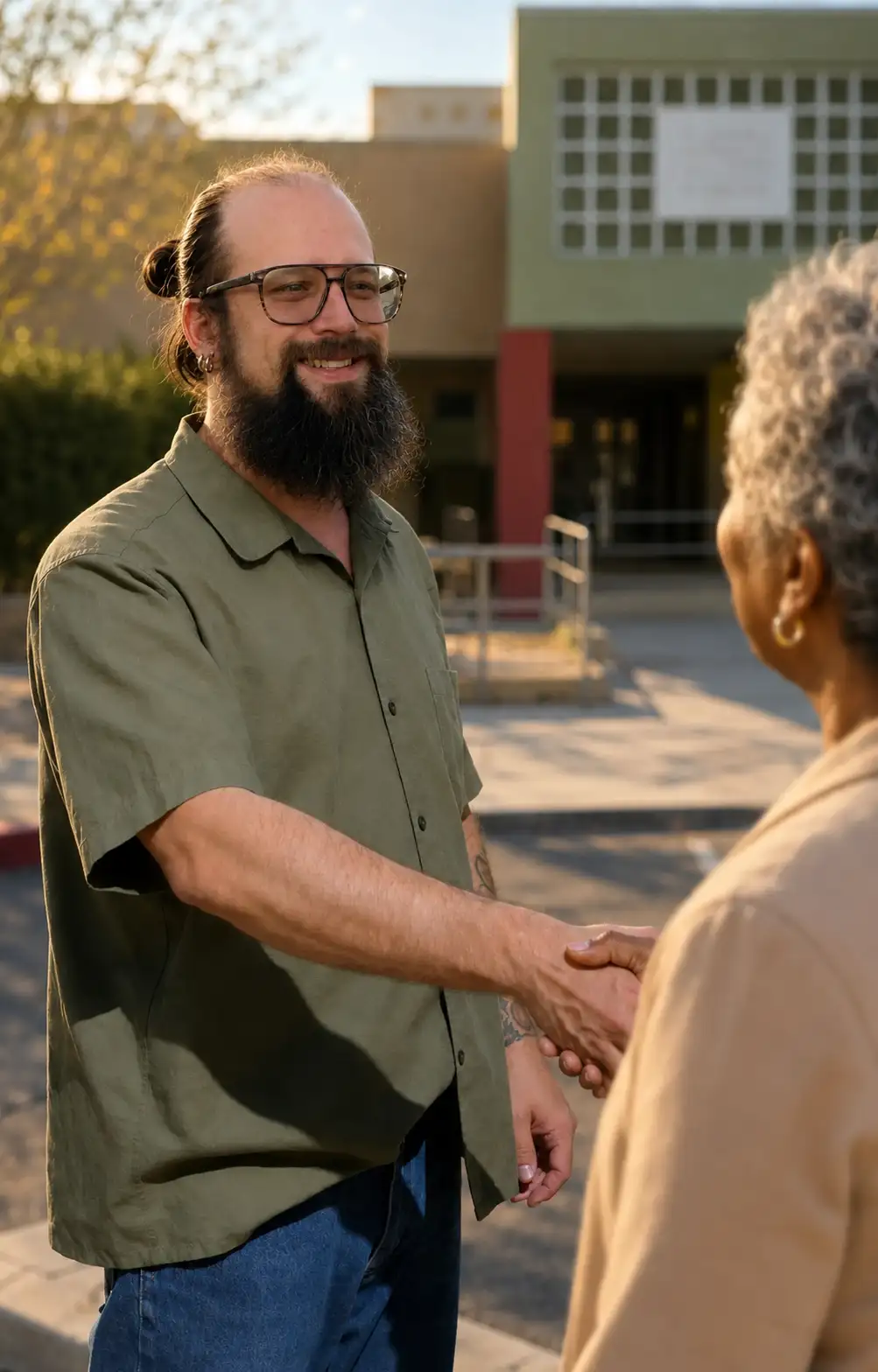 Vadim Altschuler greeting a community member outdoors